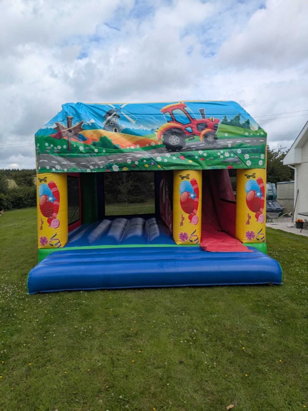 Farm-themed bouncy castle with tractor and slide for parties in Cork