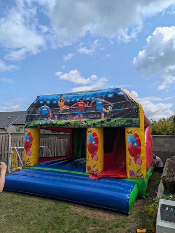 Football-themed bouncy castle with slide for parties in Cork