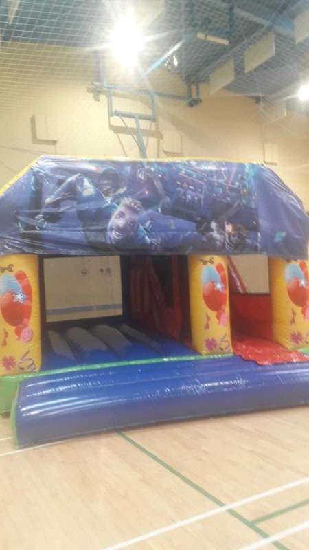 Fortnite-themed bouncy castle with slide for parties in Cork