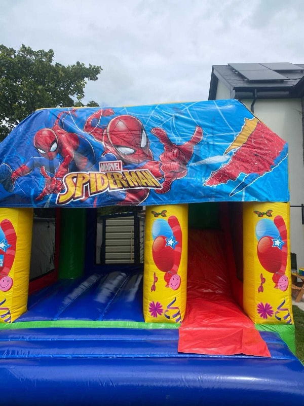 Spider-Man themed bouncy castle with slide for parties in Cork