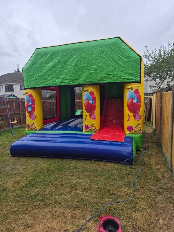 Colourful bouncy castle with slide for parties in Cork