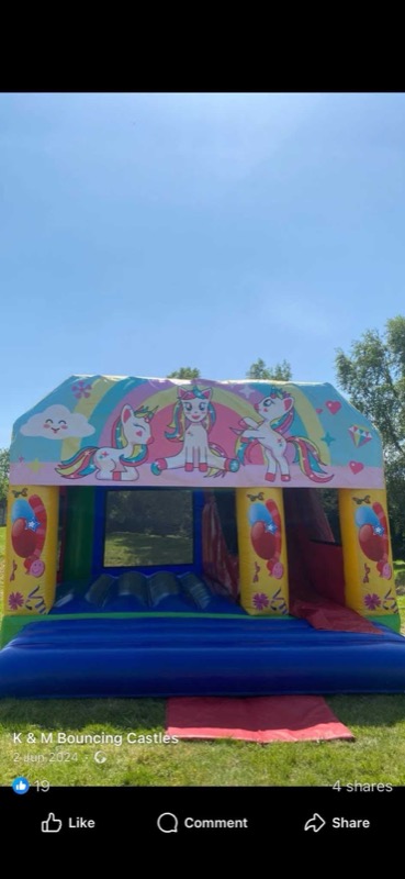 Unicorn and rainbow-themed bouncy castle with slide for parties in Cork