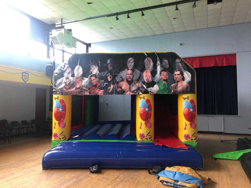 WWE wrestling-themed bouncy castle with slide for parties in Cork