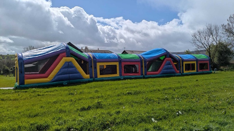 Multi-section obstacle course with tunnels and climbing walls for parties in Cork