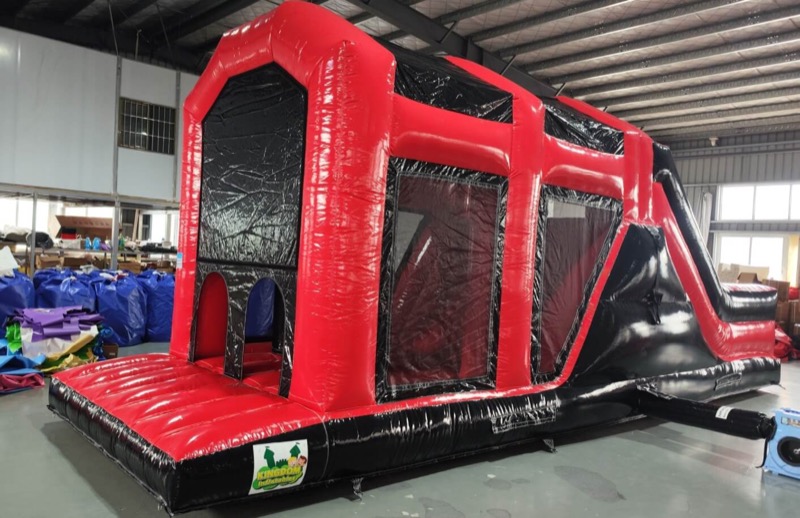 Red and black obstacle course with slide for parties in Cork